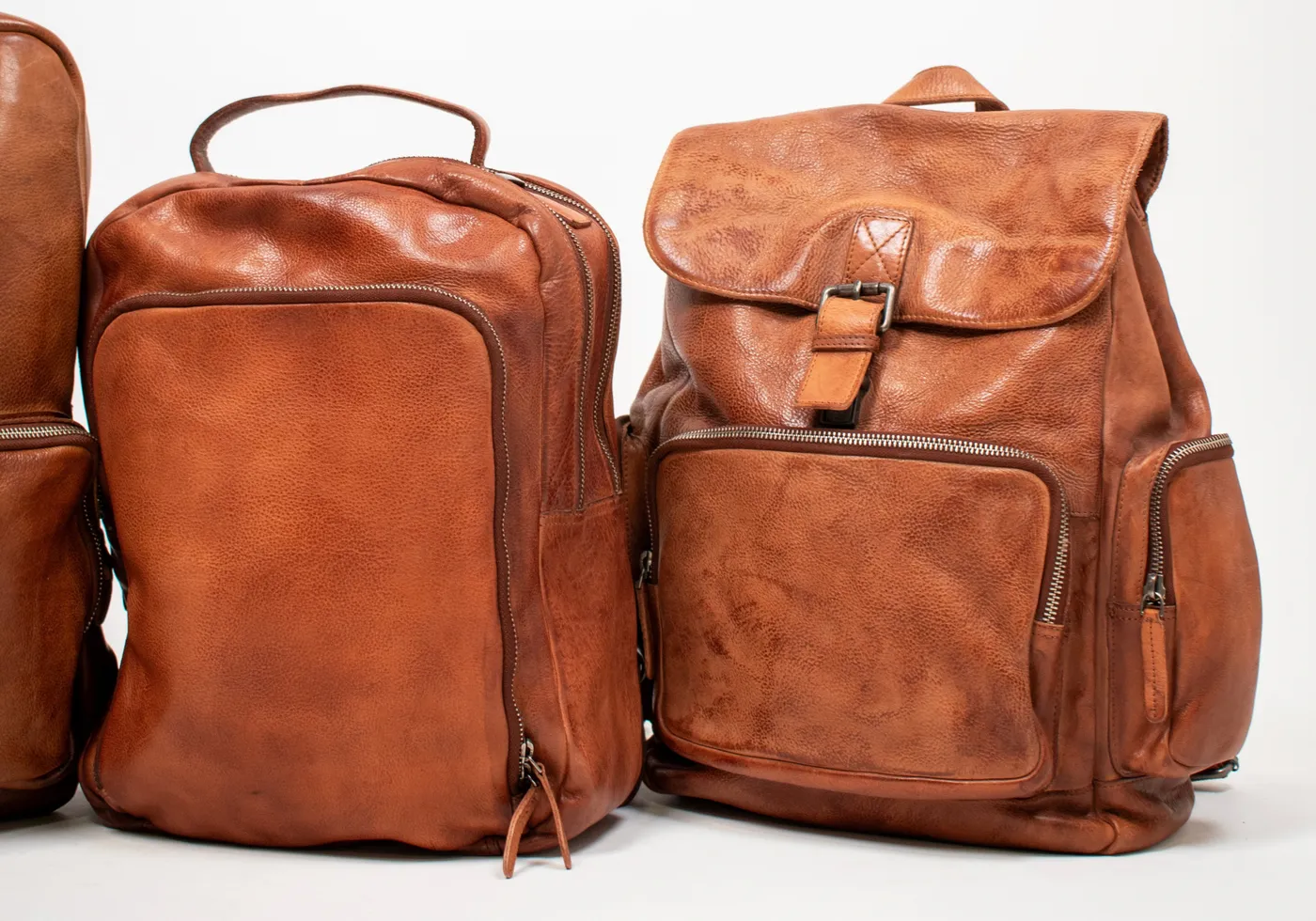 Two cognac leather backpacks, from the Latico home page.