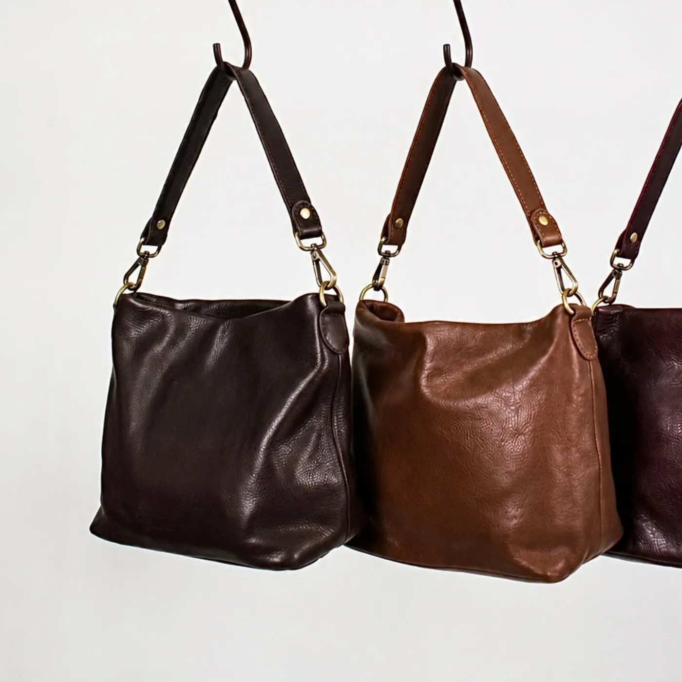 Tabor crossbody bags in cafe leather, from the Latico home page.