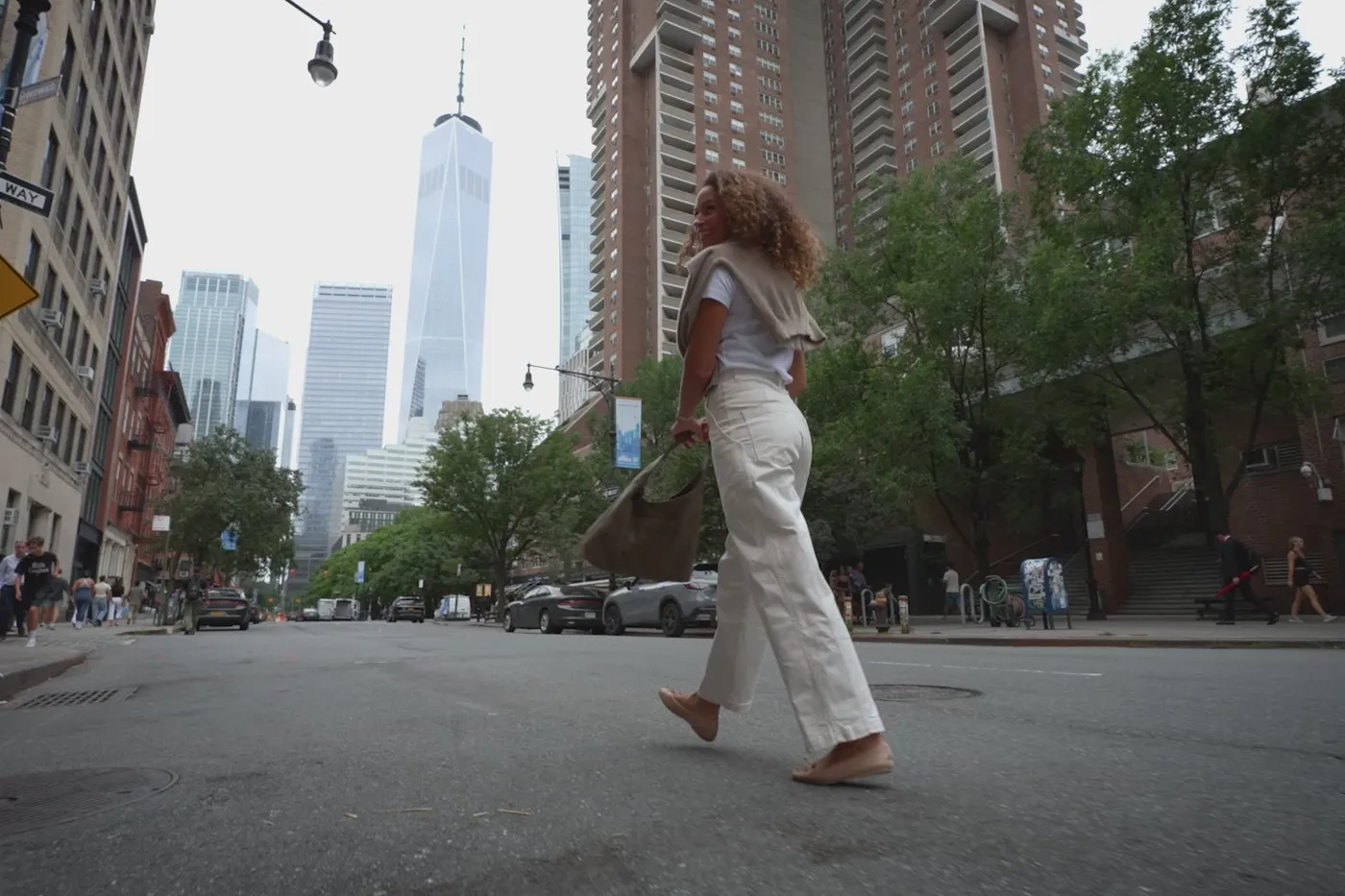 A woman walks across a New York street carrying a Latico leather bag, from the Latico home page film.